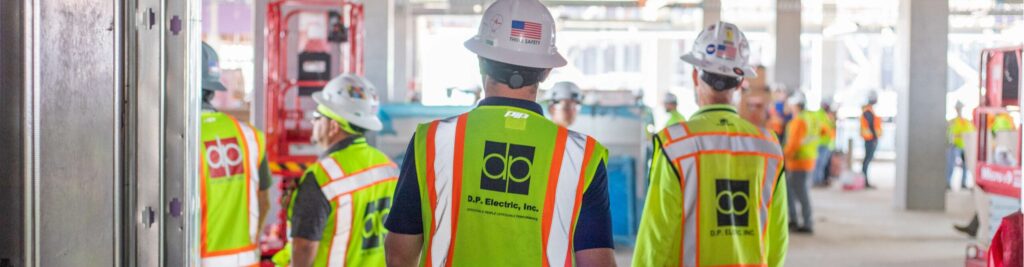 DP Electric workers in a hallway.
