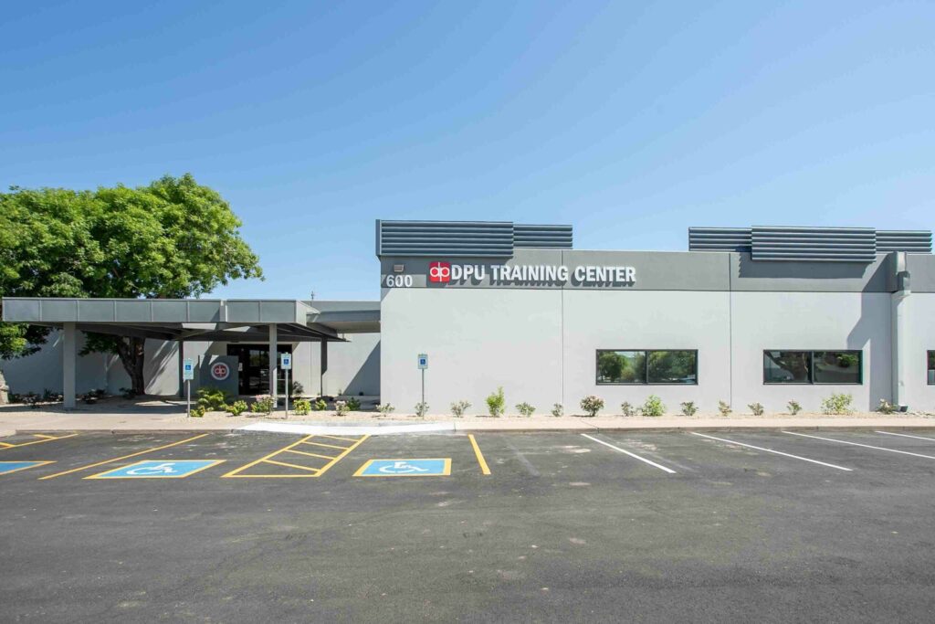 A building with a parking lot in front of it.